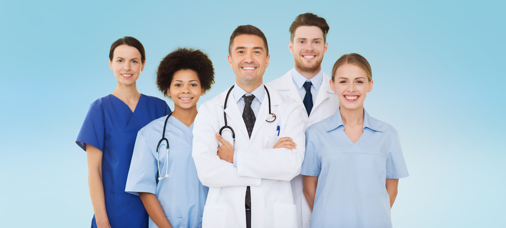 hospital, profession, people and medicine concept - group of happy doctors over blue background